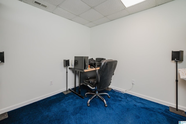 carpeted home office with a drop ceiling