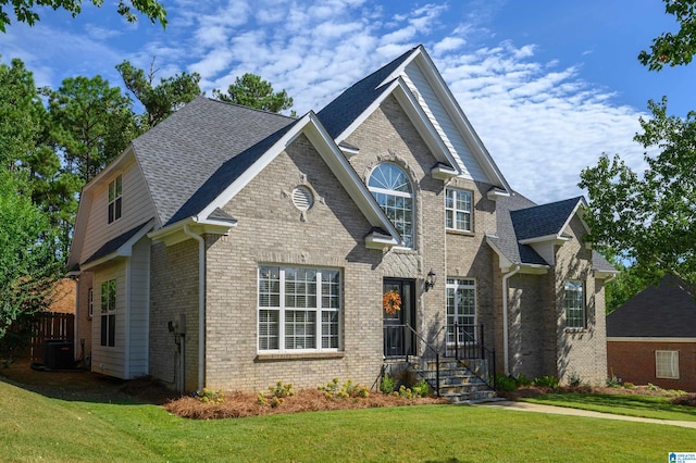 view of front facade with central AC unit and a front yard