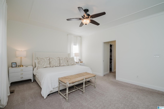 carpeted bedroom with crown molding and ceiling fan