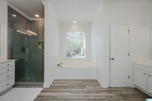 bathroom with ornamental molding, vanity, independent shower and bath, and hardwood / wood-style floors