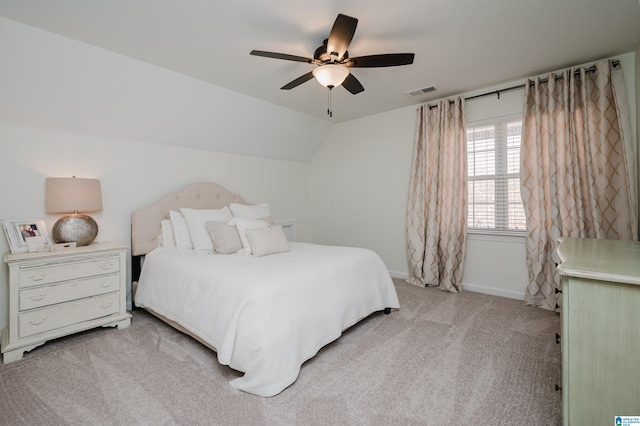 bedroom with ceiling fan, light colored carpet, and vaulted ceiling