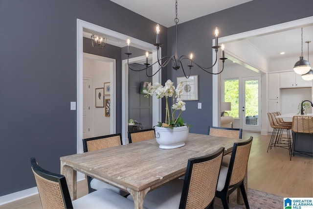 dining area with light hardwood / wood-style flooring and french doors