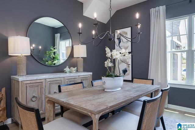 dining space featuring wood-type flooring and lofted ceiling