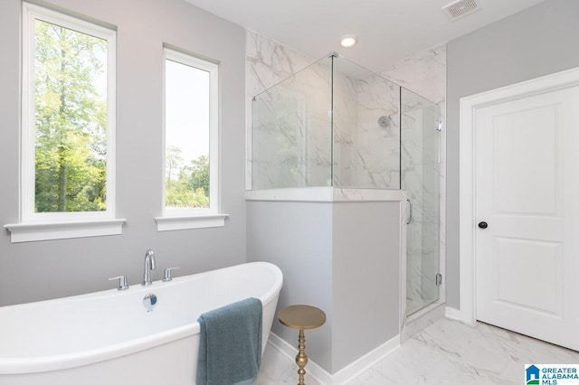 bathroom featuring a wealth of natural light and plus walk in shower