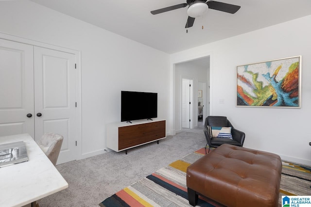 carpeted living room with ceiling fan