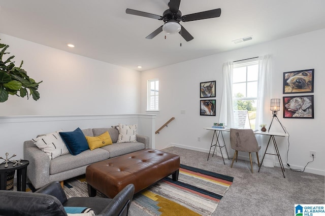 carpeted living room with ceiling fan