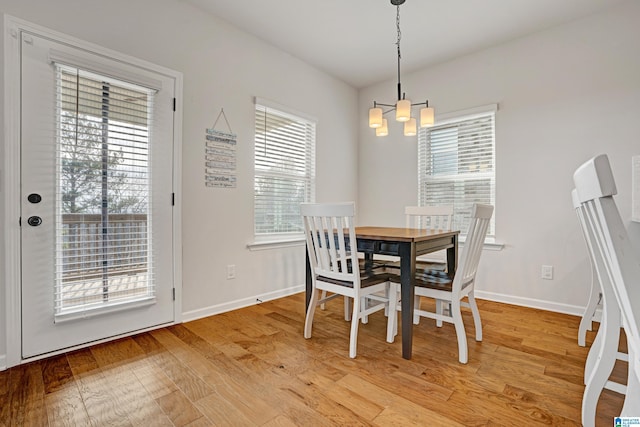 dining room featuring hardwood / wood-style flooring and an inviting chandelier