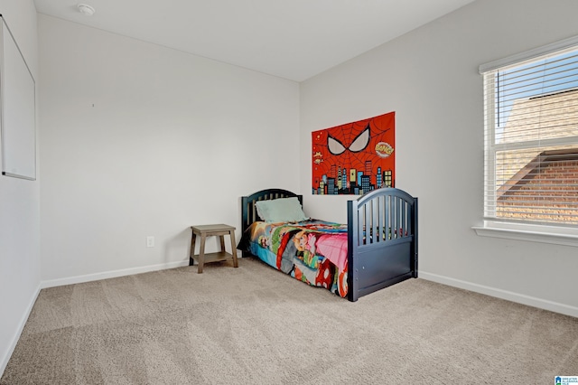 bedroom featuring carpet floors and multiple windows