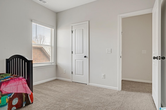 bedroom with light colored carpet