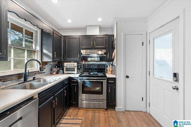 kitchen with appliances with stainless steel finishes, sink, decorative backsplash, and plenty of natural light