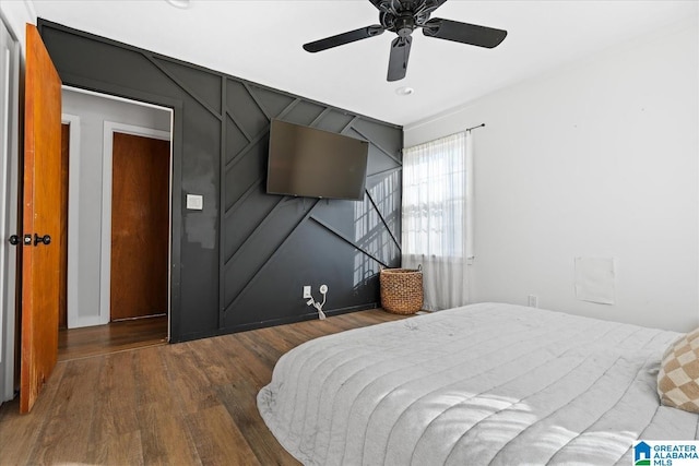 bedroom with hardwood / wood-style floors and ceiling fan