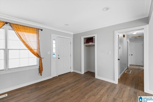 entrance foyer featuring crown molding and dark hardwood / wood-style flooring