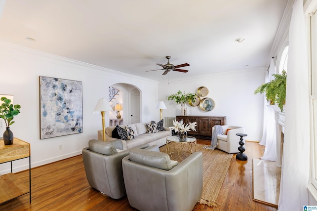 living room featuring ornamental molding, hardwood / wood-style floors, and ceiling fan