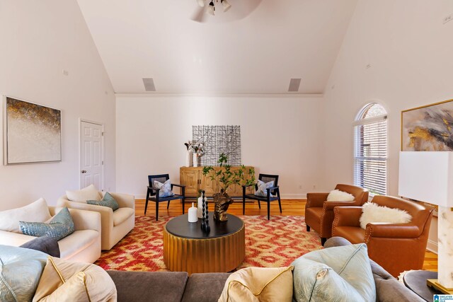 living room with hardwood / wood-style flooring and high vaulted ceiling