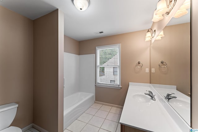 bathroom featuring tile patterned flooring, vanity, a bathtub, and toilet