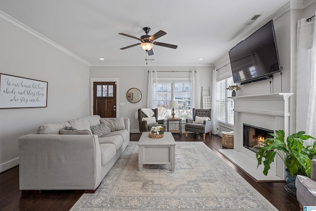 living room with dark hardwood / wood-style flooring, ornamental molding, and ceiling fan