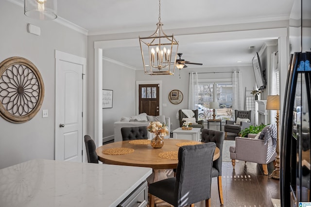 dining room featuring ornamental molding and ceiling fan with notable chandelier