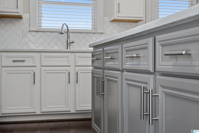 kitchen featuring white cabinetry, sink, and a wealth of natural light