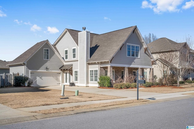 view of front of property featuring cooling unit and a garage