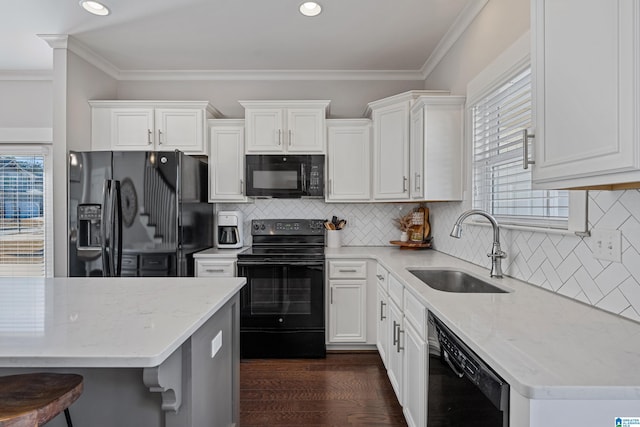 kitchen featuring sink, light stone counters, black appliances, dark hardwood / wood-style floors, and white cabinets