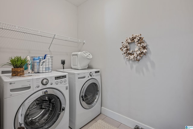 laundry area featuring light tile patterned floors and independent washer and dryer