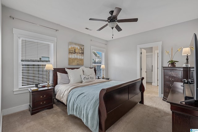 bedroom with light carpet and ceiling fan