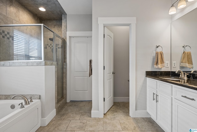 bathroom with vanity and shower with separate bathtub