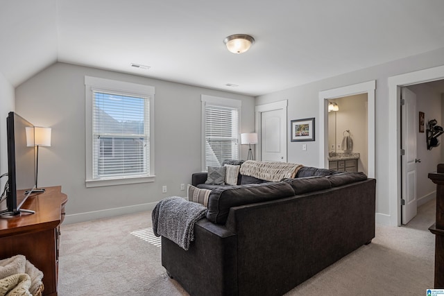 living room with vaulted ceiling and light colored carpet