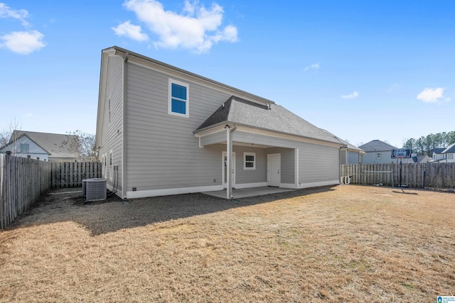 back of property with a yard, central AC, and a patio