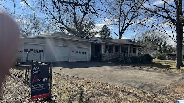 single story home featuring a garage and covered porch