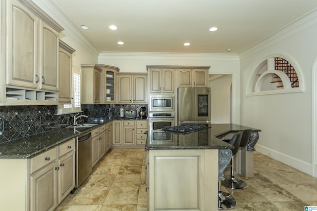 kitchen with stainless steel appliances, a center island, a kitchen bar, light brown cabinetry, and dark stone counters