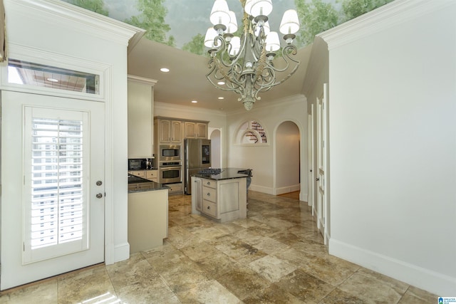 kitchen featuring pendant lighting, ornamental molding, a center island, stainless steel appliances, and an inviting chandelier