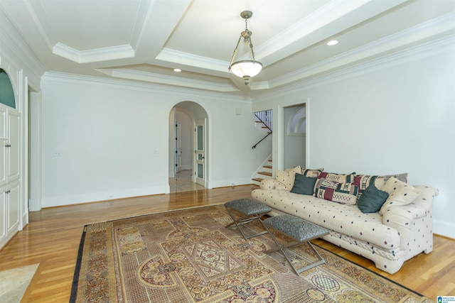 living room featuring wood-type flooring and ornamental molding