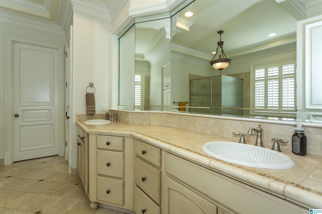 bathroom featuring a shower with door, ornamental molding, and vanity