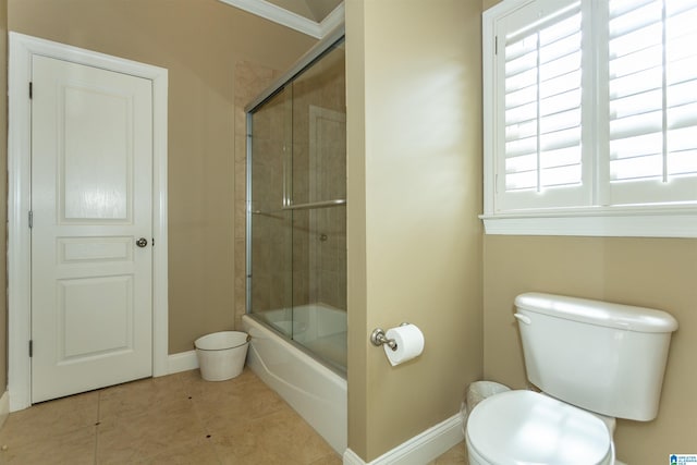 bathroom with toilet, bath / shower combo with glass door, and tile patterned flooring