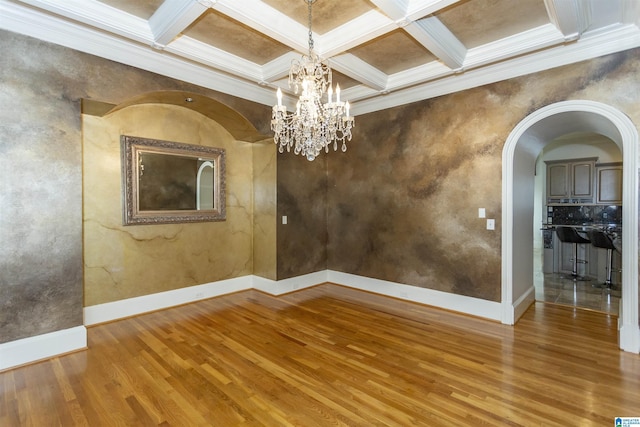 interior space with ornamental molding, wood-type flooring, and coffered ceiling