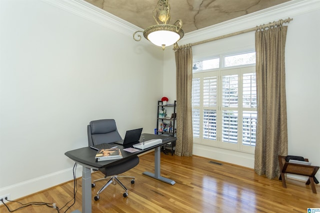 home office with hardwood / wood-style flooring and ornamental molding