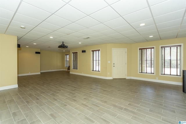 unfurnished room featuring a wealth of natural light and a paneled ceiling