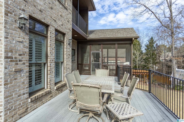 wooden deck featuring a sunroom