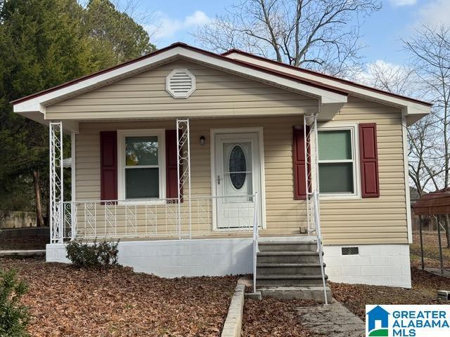 view of front of house with a porch and crawl space