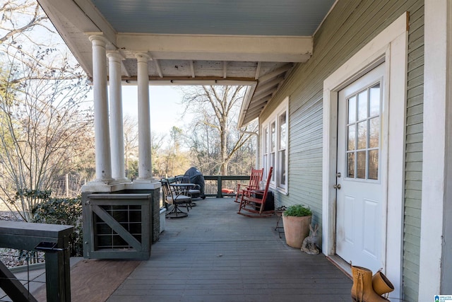 wooden terrace featuring covered porch