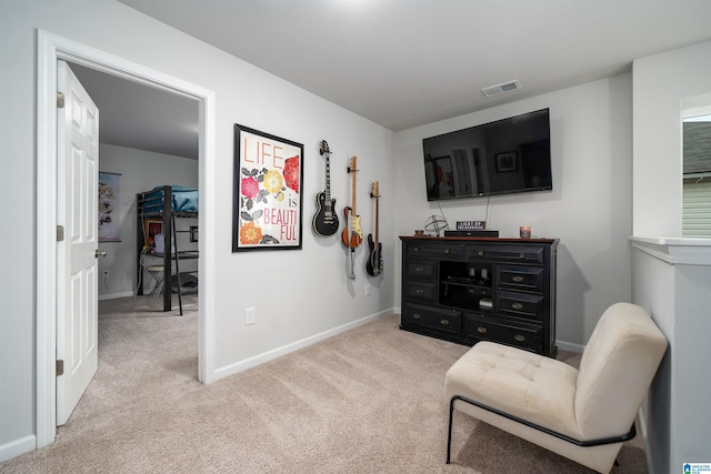 living area featuring light carpet