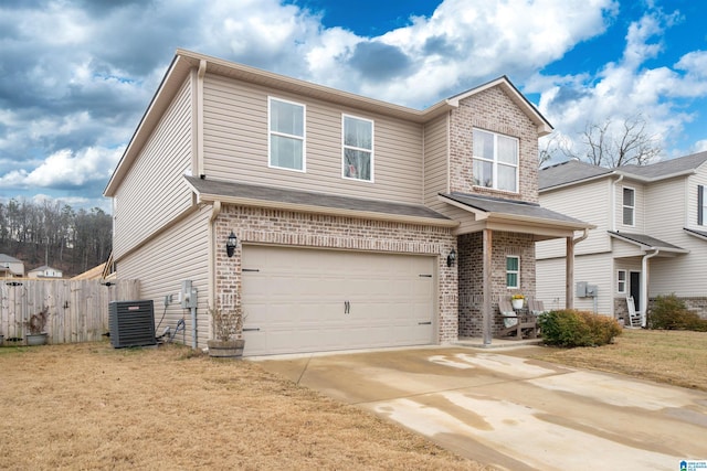 view of front of property featuring cooling unit, a garage, and a front lawn