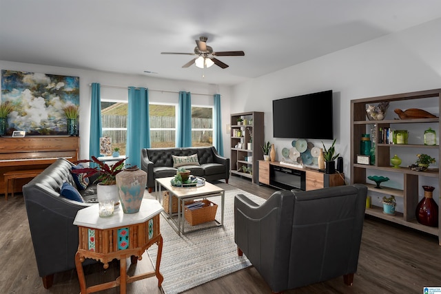 living room featuring ceiling fan and dark hardwood / wood-style floors