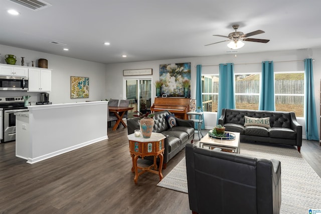 living room featuring dark hardwood / wood-style floors and ceiling fan