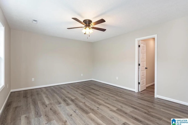 unfurnished room featuring hardwood / wood-style flooring and ceiling fan