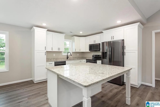 kitchen featuring white cabinetry, black appliances, and a kitchen island