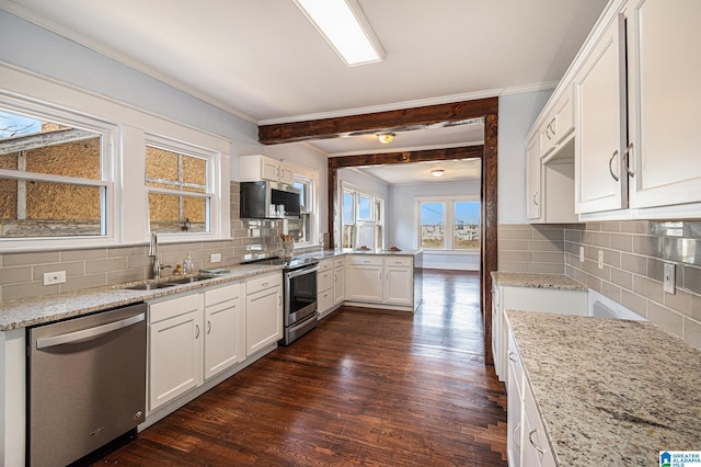 kitchen featuring white cabinetry, sink, dark wood-type flooring, and appliances with stainless steel finishes