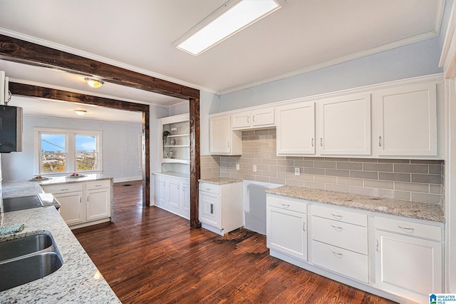 kitchen with white cabinetry, light stone countertops, dark hardwood / wood-style floors, and backsplash