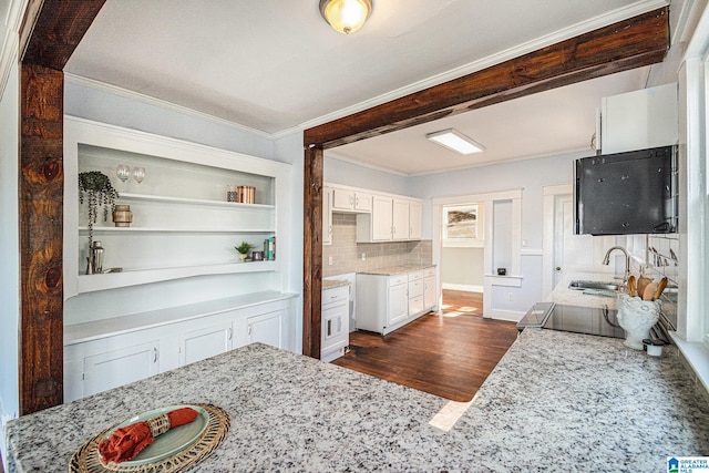 kitchen with white cabinetry, light stone countertops, sink, and range